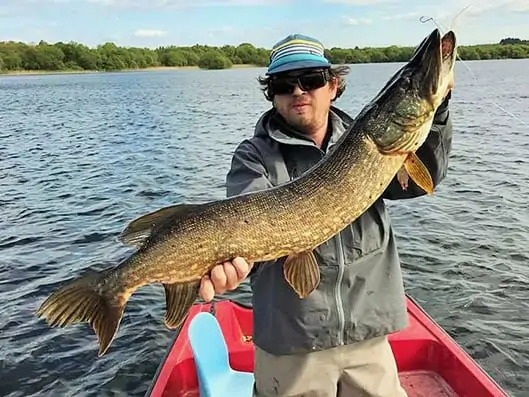 Angler holding large Pike